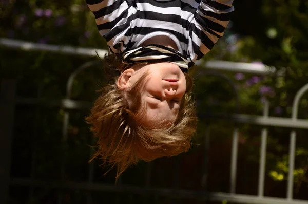 Little Boy Hangs Upside Horizontal Bar Boy Long Hair Upside — Stock Photo, Image