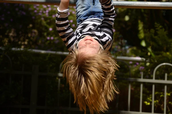 Little Boy Hangs Upside Horizontal Bar Boy Long Hair Upside — Stock Photo, Image