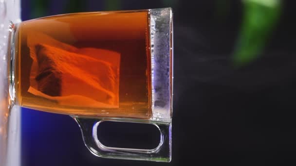 Glass Cup Tea Black Tea Bag Dissolves Hot Water Steam — Stock Video