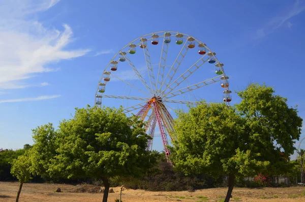 stock image Ferris wheel against the blue sky in a summer park