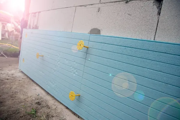 Stock image The installation of insulation extruded polystyrene panels .