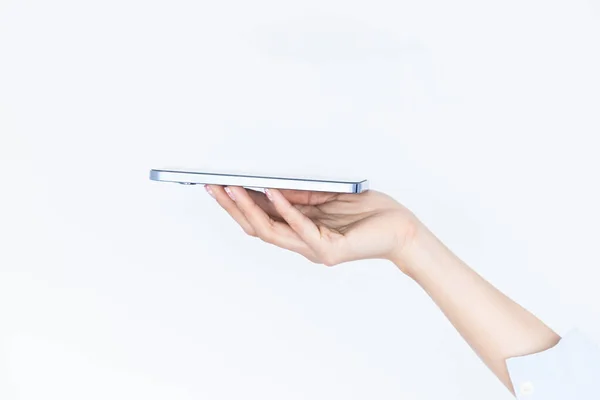 stock image Woman hand holding an empty smartphone isolated on white background, Female waitress hand using smart phone, Concept of digital service .