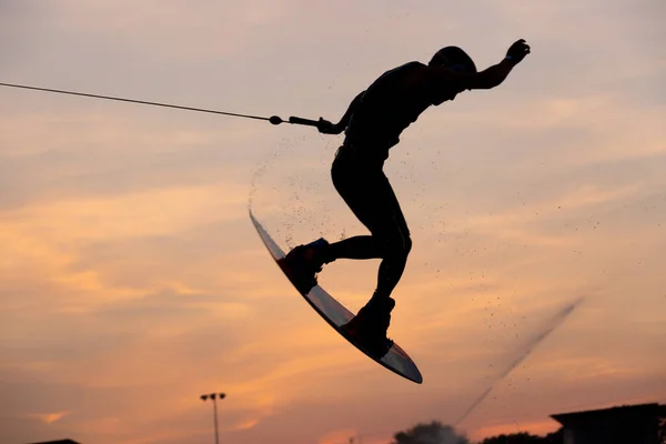 Silhouette Wakeboarder Trükköket Csinál Naplementekor Young Surfer Wakeboarding Kábel Parkban — Stock Fotó
