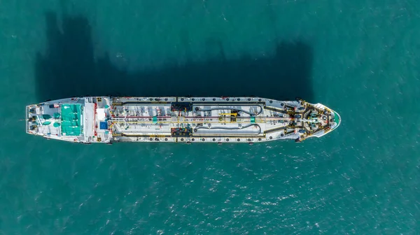 Aerial top view ship tanker crude oil on the sea for transportation, Sea transportation of crude oil petroleum tanker to oil terminal for loading and global business loogistic.