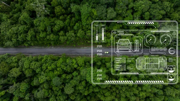 Aerial top view of green electric vehicle car driving over straight forest road, Green EV car electric vihicle car on forest road with green energy and eco power produced from sustainable.