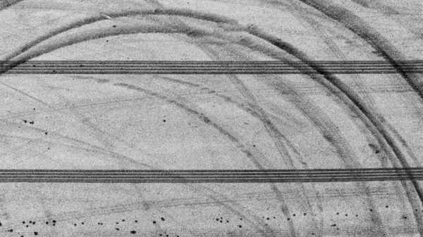 Aerial view tire track mark on asphalt tarmac road race track texture and background, Abstract background black tire track skid on asphalt road, Tire mark skid mark on asphalt road.