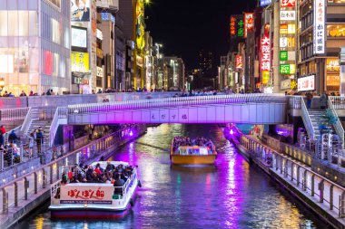 Osaka, Japan-November 21, 2017 : Tourist walking in night shopping street at Dotonbori or Dotomburi, Dotonbori the famous destination for traveller in Shinsaibashi, Osaka City, Namba, Osaka, Japan. clipart