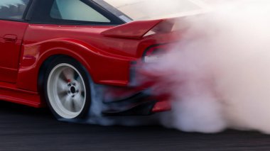 Yarış arabasının tekerleği patinaj lastiği patinaj, beyaz duman yarış arabasının lastiği patinaj, yarış arabasının tekerleği patinaj lastiği, yarış pistinde motorsporunun tekerleği yanar..