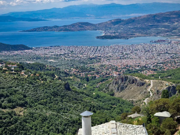View of Volos seaside city from the traditional greek village of Makrinitsa on Pelion mountain in central Greece on a summer day