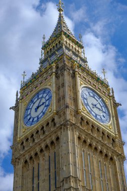 Big Ben saati kısmen bulutlu mavi gökyüzüne ayarlı. Londra 'nın simgesi.