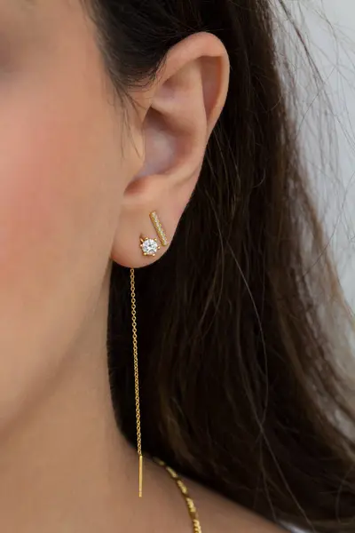 Woman wearing beautiful dangky and stud earrings with zirconia. Beautiful valentine\'s gift.