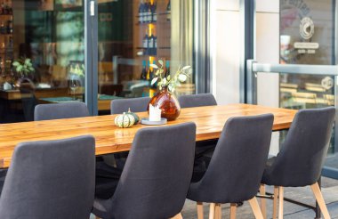 Restaurant interior tables near a restaurant. Close up shot of empty cafeteria or restaurant tables with chairs on street.