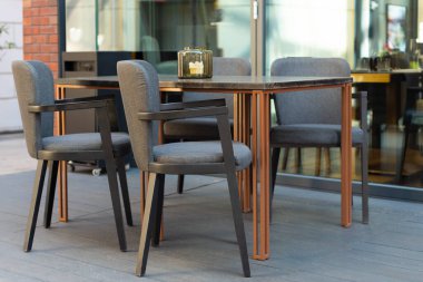 Restaurant interior tables near a restaurant. Close up shot of empty cafeteria or restaurant tables with chairs on street