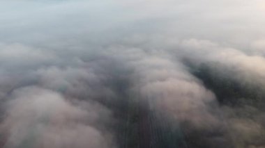 Aerial top view over the fog, in the Romanian countryside