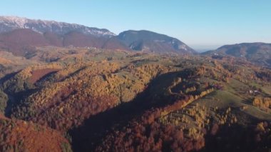 Autumn rural scene of the Romanian traditional village in Transylvania. Aerial colorful landscape at the foot of the Carpathian Mountains