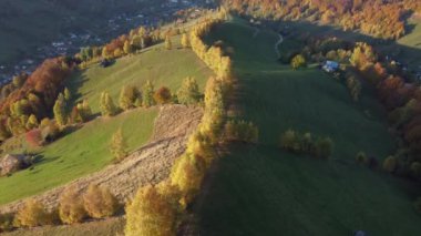 Autumn rural scene of the Romanian traditional village in Transylvania. Aerial colorful landscape at the foot of the Carpathian Mountains