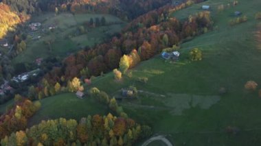 Autumn rural scene of the Romanian traditional village in Transylvania. Aerial colorful landscape at the foot of the Carpathian Mountains