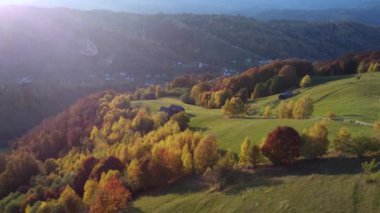 Autumn rural scene of the Romanian traditional village in Transylvania. Aerial colorful landscape at the foot of the Carpathian Mountains