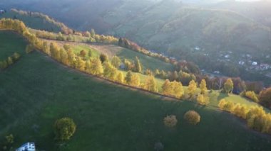 Autumn rural scene of the Romanian traditional village in Transylvania. Aerial colorful landscape at the foot of the Carpathian Mountains