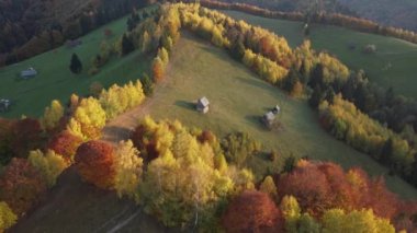 Autumn rural scene of the Romanian traditional village in Transylvania. Aerial colorful landscape at the foot of the Carpathian Mountains