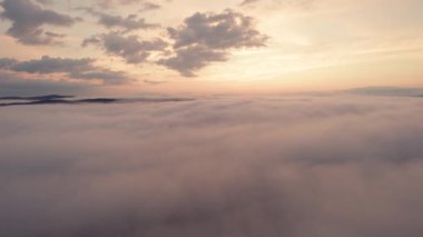 Bulutların üzerindeki hava manzarası, gün doğumunda