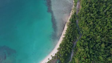 Gün batımında harika palmiye ağaçları ve kristal berrak mavi suyu olan güzel White Beach 'in 4K Hava Aracı videosu. Barton Limanı, Filipinler