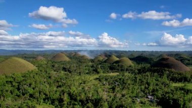 Filipinler 'in Bohol Adası' ndaki Chocolate Hills 'te doğanın güzelliği ile ilgili 4K hava aracı videosu. Bu isim, kurak mevsimde tepeleri kaplayan ve kahverengileşen çimlerden geliyor.