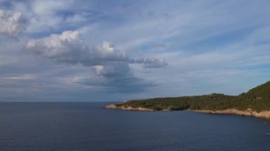 4K Hava Aracı, İspanya 'nın Mallorca adasındaki Mirador Badia de Pollenca adasında ikonik bir gemi ve uçurumlarla büyüleyici bir günbatımı videosu.