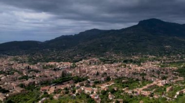 4K Hava Aracı, çevredeki dağlara yerleşmiş deniz manzaralı terasotta evleri ve merkezde tren Soller, Mallorca ile birlikte bir katedrali olan sihirli bir kasabanın videosu.