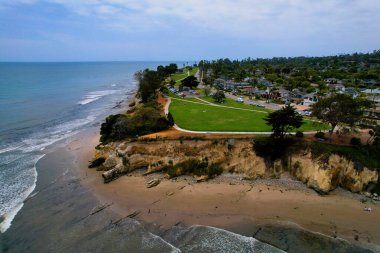 Aerial view of world famous Santa Barbara with mountains as dramatic backdrop. West Coast California USA. Pacific Ocean. Cliffs with palm trees and a huge marina port with hundreds of boats