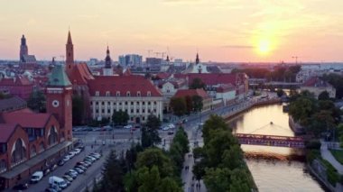 4k aerial footage view of the Oder River, old center of the city of Wroclaw in Poland. Summer scene in the town on weekend peacefull evening. classical architecture. Buildings with red roofs. Europe.