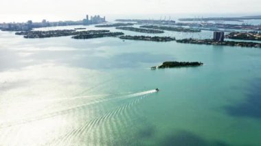 4k drone görüntüsü. Renkli yeşil Biscayne Körfezi ve güneşli bir günde Miami Limanı 'ndaki adaların manzarası. Florida 'nın taşıma su altyapısı. Ahlak masasında yatlarda tatil.