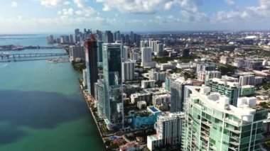 Güneşli bir günde Miami şehir merkezindeki cam gökdelenlerin üzerinden 4K drone görüntüleri uçuyor. Metropolün şehir manzarasının havadan görüntüsü. Biscayne Körfezi 'nin rıhtımında gayrimenkul. Florida ABD