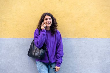 Woman talking on the phone outdoors. Technology concept.