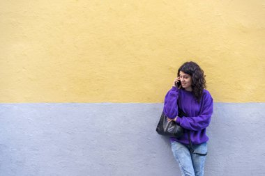 Woman talking on the phone outdoors. Technology concept.
