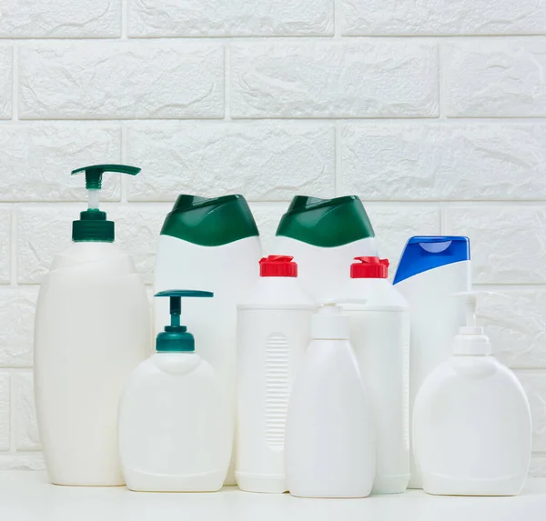 stock image Empty plastic white bottles for cosmetics and other liquid substances on a white background. Blank for branding gel, shampoo, detergent