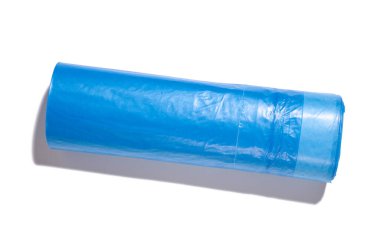 Blue plastic trash bags with strings on white background, top view
