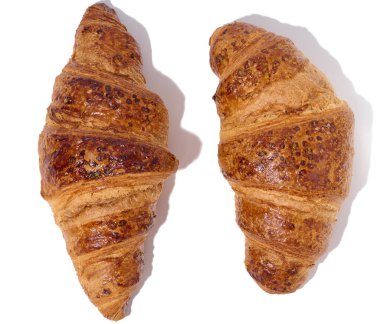 Baked croissant on a white isolated background, top view