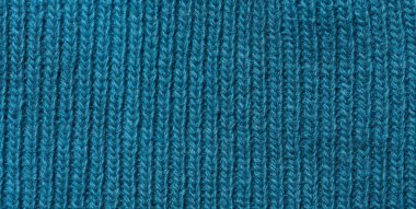 Texture of a knitted blue fabric. Detail of clothing