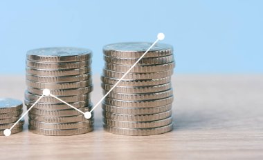 A stack of metallic coins and a chart with growing rates. High income in business, price increase, profit analysis