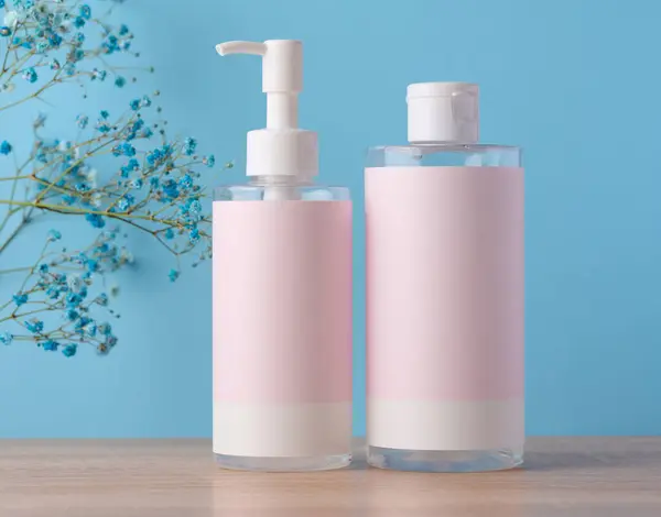 Two Bottles Cosmetics Pink Paper Label Blue Background Bottle Tonic — Foto de Stock