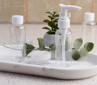 Transparent plastic container for cosmetics on the table, bottles for liquid cosmetics