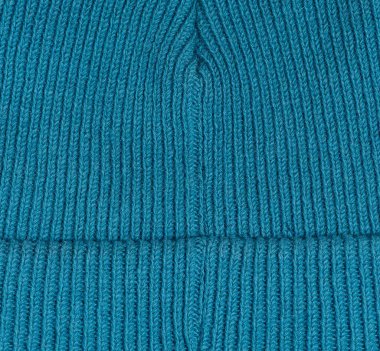 Texture of a knitted blue fabric. Detail of clothing