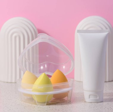 White plastic tub and oval sponge for makeup, cosmetic procedure tools