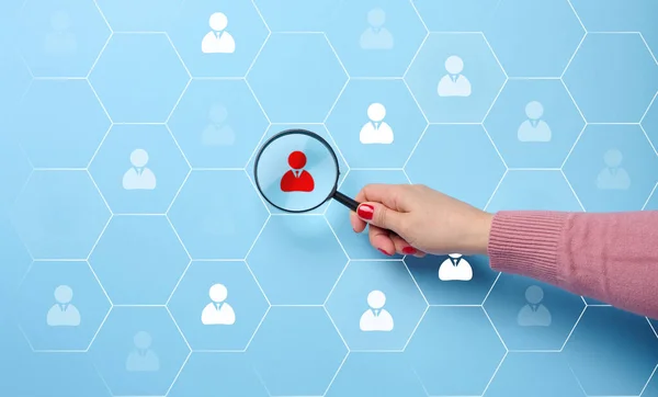 Search and selection of personnel in the company. Effective personnel management, leader identification. Magnifying glass and staff icons on blue background