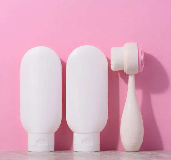 White Plastic Tubes Cream Massaging Brush Facial Cleansing Pink Background — Stock Photo, Image