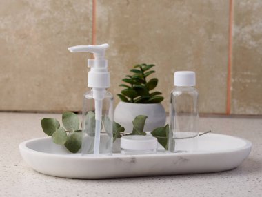 Transparent plastic container for cosmetics on the table, bottles for liquid cosmetics