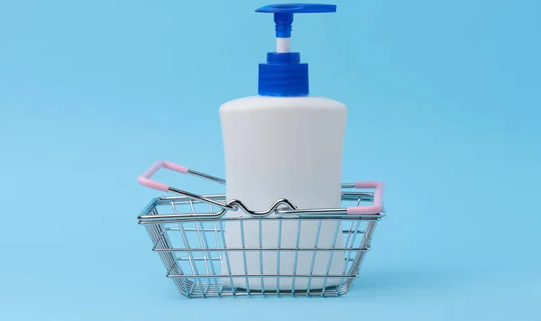 White plastic container with a pump for cosmetic liquid, liquid soap