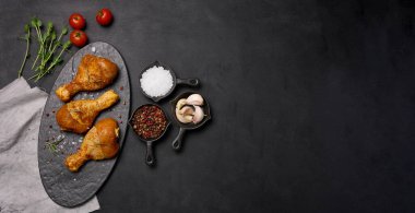 Kara tahtada baharatlı tavuk budu, üst manzara. Baharatlı yemek pişirme, alanı kopyala