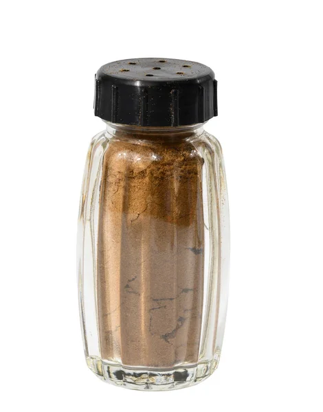 stock image Transparent glass jar with ground cinnamon on a white isolated background, spice